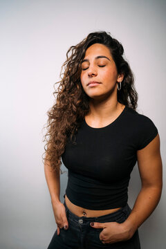 Young woman with curly hair finding inner peace and serenity