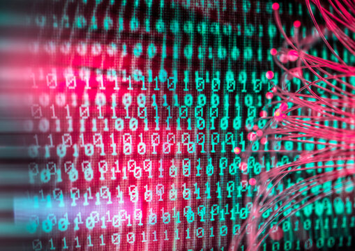 Glowing fiber optic cable attacking computer binary code