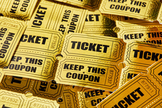 Golden raffle ticket background with overlapping tickets