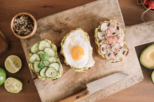 Slice of food garnished with fresh vegetable and guacamole on serving dish at kitchen