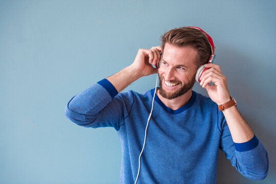 Smiling man listening to music with headphones