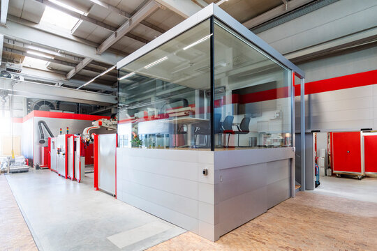 Modern factory interior with glass office and industrial robot