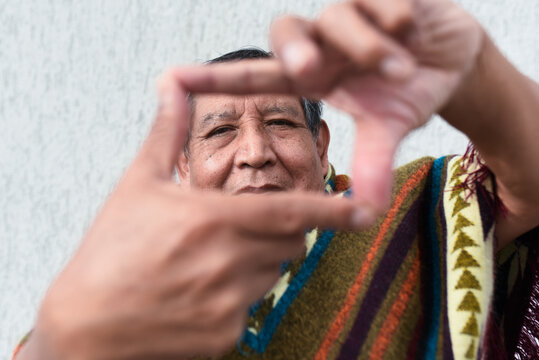Smiling senior man making finger frame