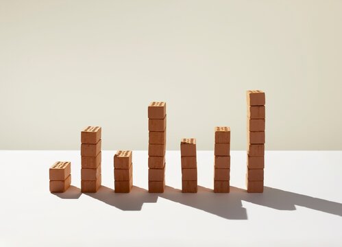 Red bricks stacked in a bar chart formation showing progress