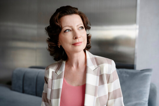 Confident businesswoman contemplating in modern office