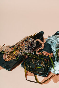 Diving flipper entangled in a net and plastic waste