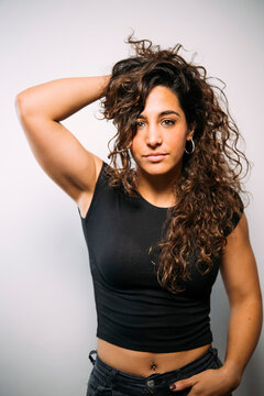 Confident young woman posing with curly hair