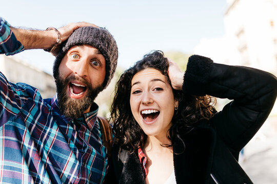 Playful young couple pulling faces