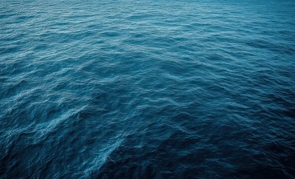deep blue ocean surface with gentle ripples and subtle light, serene and expansive