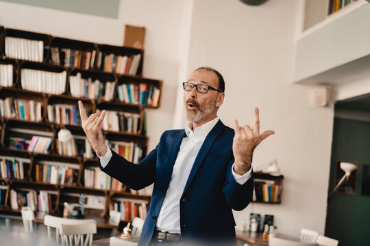 Exuberant mature businessman in a cafe