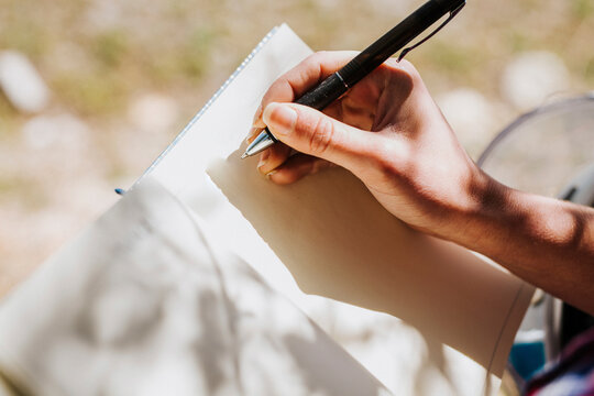 Woman's hand taking notes, close-up