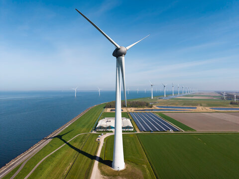 Wind turbine and solar panel by IJsselmeer in the Netherlands