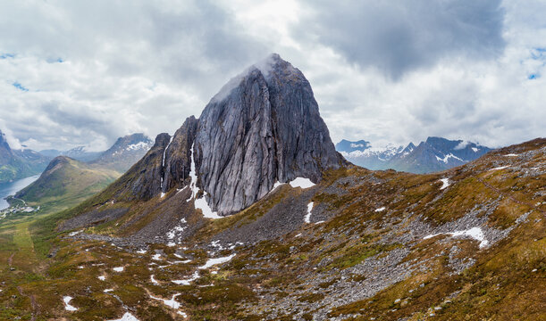 Majestic Segla mountain peak with dramatic cloudy sky on Senja Island, Norway