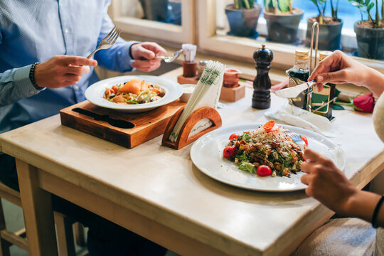 Couple having dinner in a restaurant, partial view