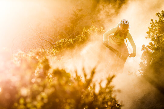 Female moutainbiker riding on dirt path during sunset, Fort Ord National Monument Park, Monterey, California, USA