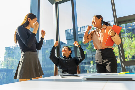 Business people having a meeting in the office. Businessman and businesswoman are celebrating success.