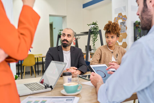 Colleagues listening to a presentation during an office meeting