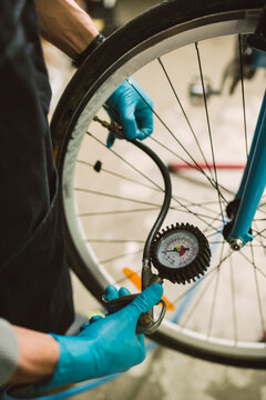 Mechanic adjusting the tire pressure of a bicycle