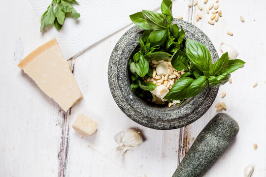 Preparing pesto alla genovese with mortar