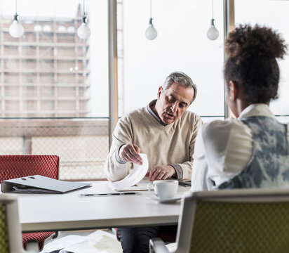 Businessman and young woman in conference room