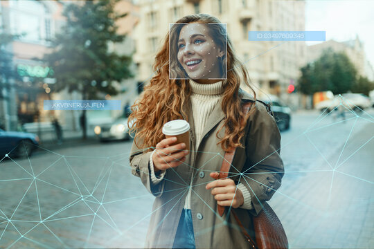 Facial recognition technology in use on a person in a city street during daytime