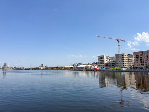 Antwerpen, Belgi&euml; &ndash; Willemdok Waterfront with Construction Crane and Urban Development on Sunny Day