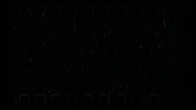 Motion graphic effect film black background featuring distressed vintage celluloid grain and retro textured light leaks for professional video editing overlay compositing