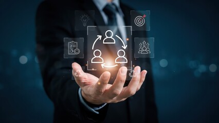 Obraz premium Businessman hand holding digital business team connection and management icons