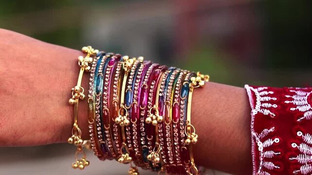 Elegant colorful bangles worn on a woman wrist captured in graceful motion for traditional video footage.