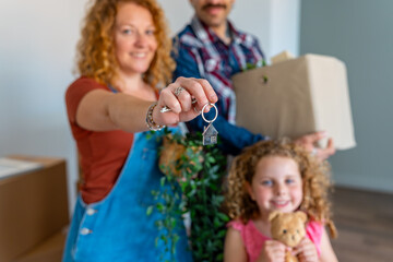 Fototapeta premium Family receiving house keys moving into new home