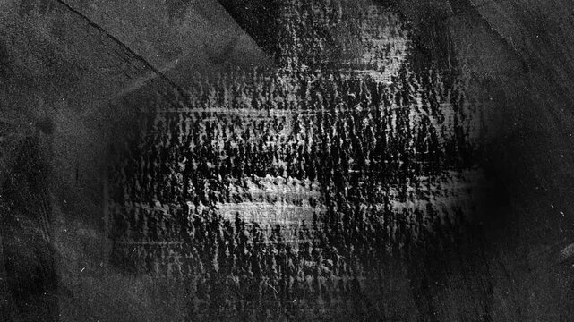 Animated abstract grunge background in black and white. Looped texture with paint strokes and scuffs.
