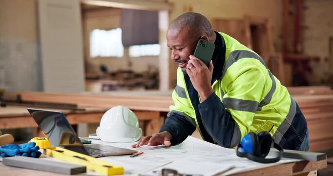 Shopfitting, laptop and man with carpentry phone call for custom project, clarify material or talk. Construction, mature black person and mobile chat in warehouse for layout design, tech and feedback