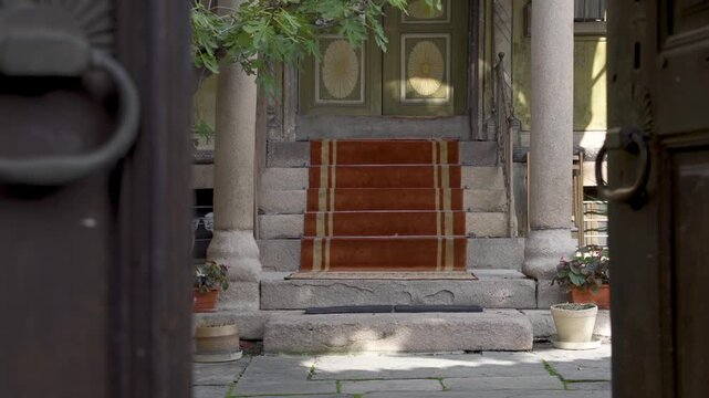 Tilt-up on the entrance of Nedkovich House in Old Town Plovdiv. The house features a four-column portico and round arches. The design follows European classicism.