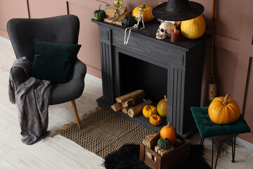 Fototapeta premium Interior of living room decorated for Halloween with black fireplace, armchair and pumpkins