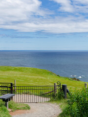 Fototapeta premium The Entrance and Exit black Iron gate to and from Stonehaven War Memorial with Downie Point Headland in the background.