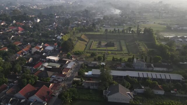 An aerial view of Sambisari Temple on a foggy morning. This Shivaist Hindu temple was built in the 9th century during the ancient Mataram Kingdom. The temple courtyard is 6.5 meters below ground level