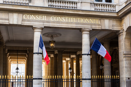 Paris, France - June 17, 2026: Portico decked with french flags at the entrance of the Constitutional Council, the highest constitutional authority in France, located in the Palais Royal.