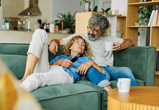 Portrait of a happy senior couple embracing talking at home