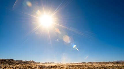 Bright sun high in clear blue sky over rocky desert symbolizing harsh summer heat and drought