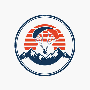 Circular paragliding logo over mountain range with sunset background.