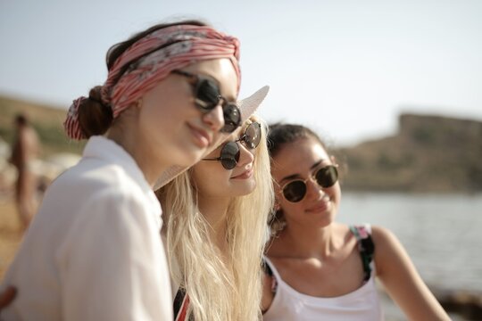 Three girlfriends in sunglasses enjoying the sunshine