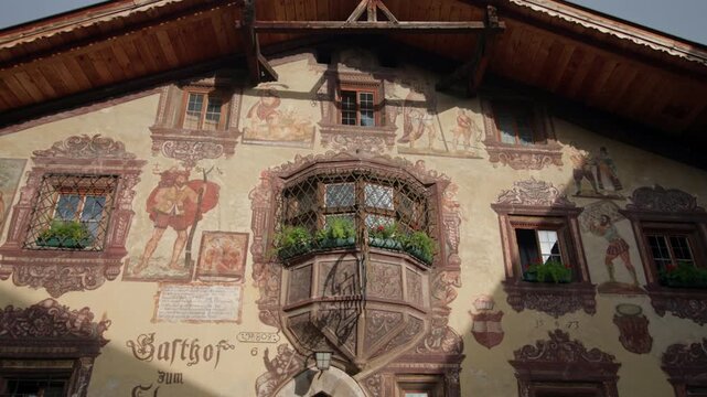 Architecture of alpine villages in the Oetz Valley, Tyrol, Austria. Authentic alpine huts with drawings in the commune of Umhausen, travel and tourism in Europe.