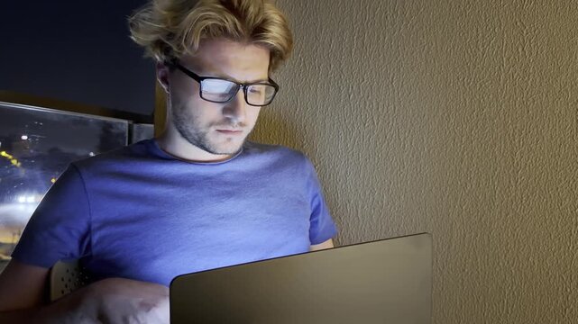 Young man working on computer at home,works remotely at a computer at home.