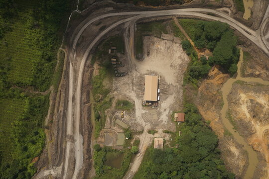Aerial view of industrial basecamp and heavy equipment yard at a construction or mining development site
