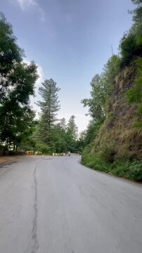 Scenery of greenery at Blue sky with this neat and clean road with mountains, Video taken on Haripur road Khyber Pakhtunkhwa, This view is caputure from the bike.