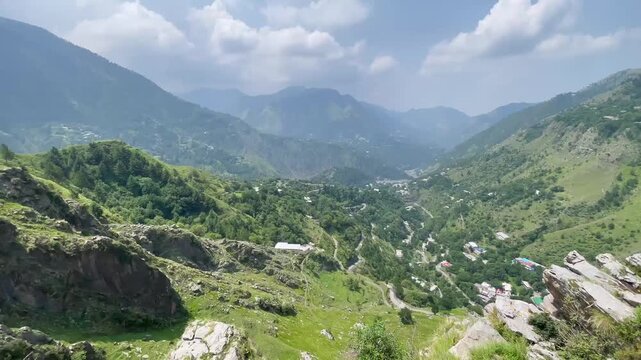 First Person POV Hiker on Rocky Mountain Cliff Overlooking Green Valley Landscape, Malsa, Abbottabad, Pakistan