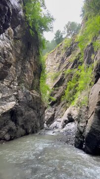 Hidden Waterfall in Rocky Mountain Gorge Reached by Hiking, Abbottabad, Khyber Pakhtunkhwa, Pakistan. Ideal for travel, adventure, hiking, ecotourism, wilderness, landscape, and outdoor Project
