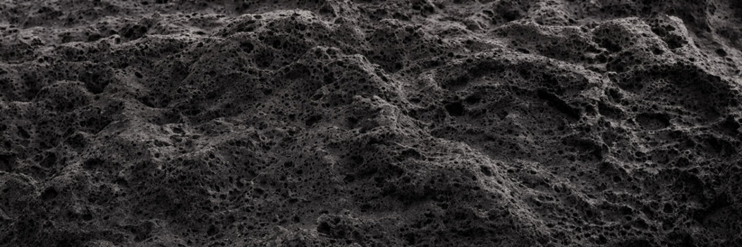 Macro view of dark porous basalt rock texture for lunar regolith and asteroid surface science concepts