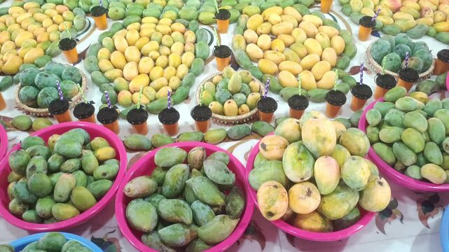 Top view of fresh mango fruits and mango juice glasses arranged in beautiful patterns for festival decoration