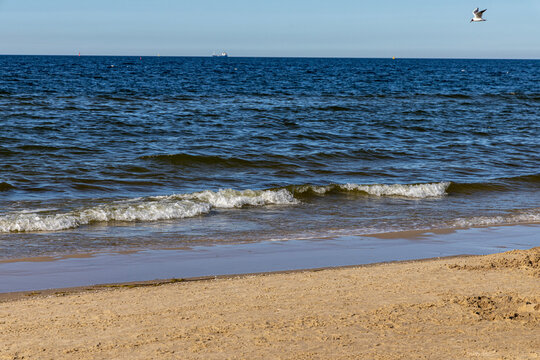 Seascape, the waves of the Baltic Sea roll onto the sandy coast of Poland.